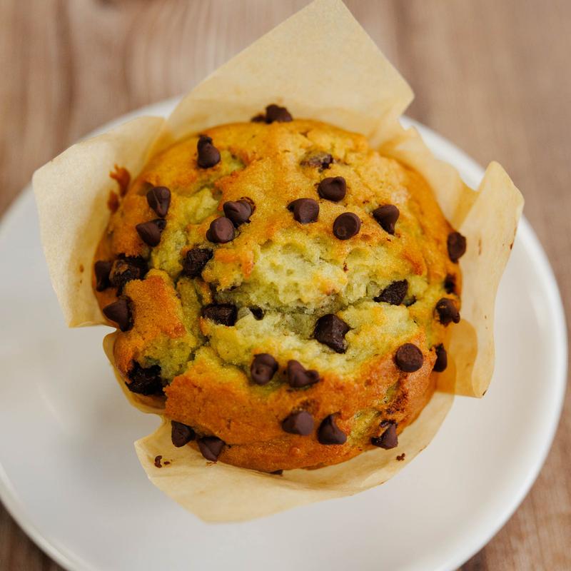 Chocolate chip muffin on a white plate