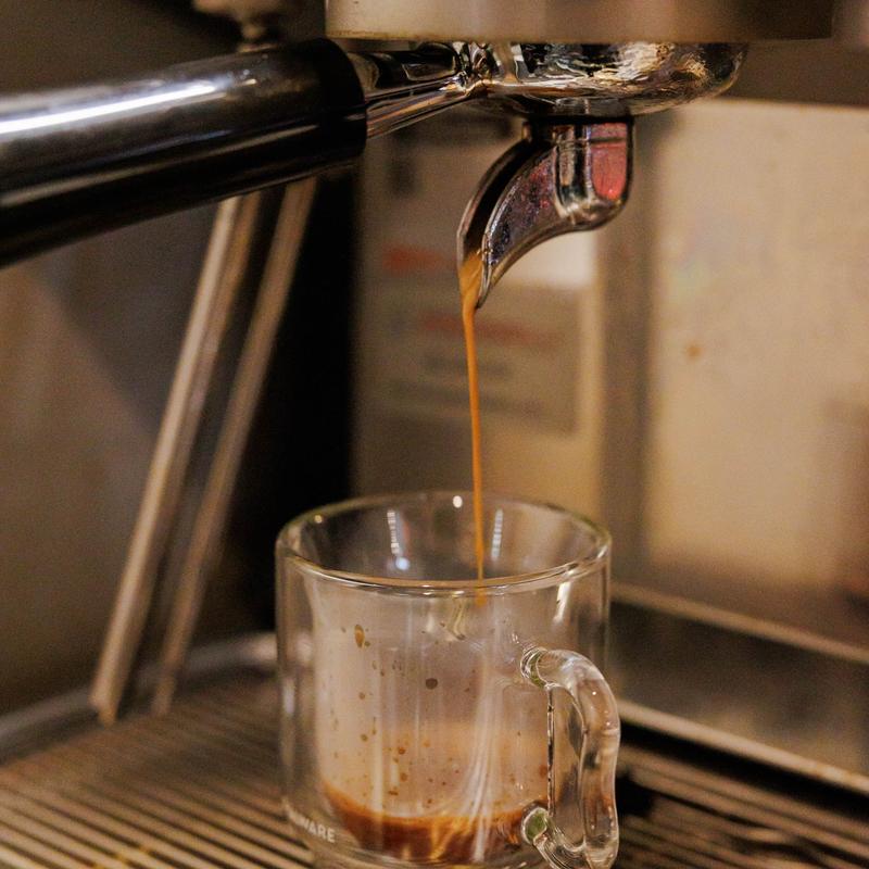 Fresh espresso pouring from the coffee machine