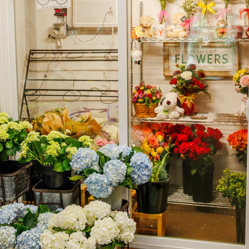 Colorful flower shop display with bouquets and wreaths