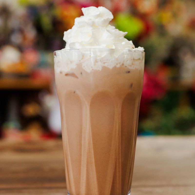 Iced chocolate drink topped with whipped cream